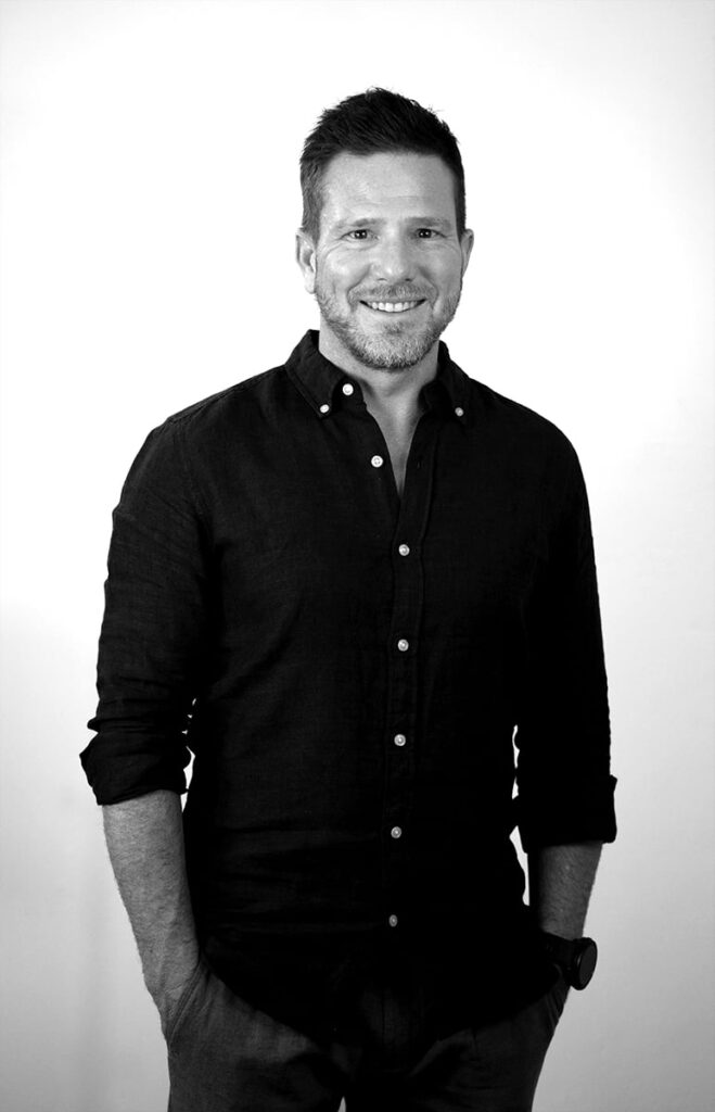 A black and white portrait of Ryan Lloyd